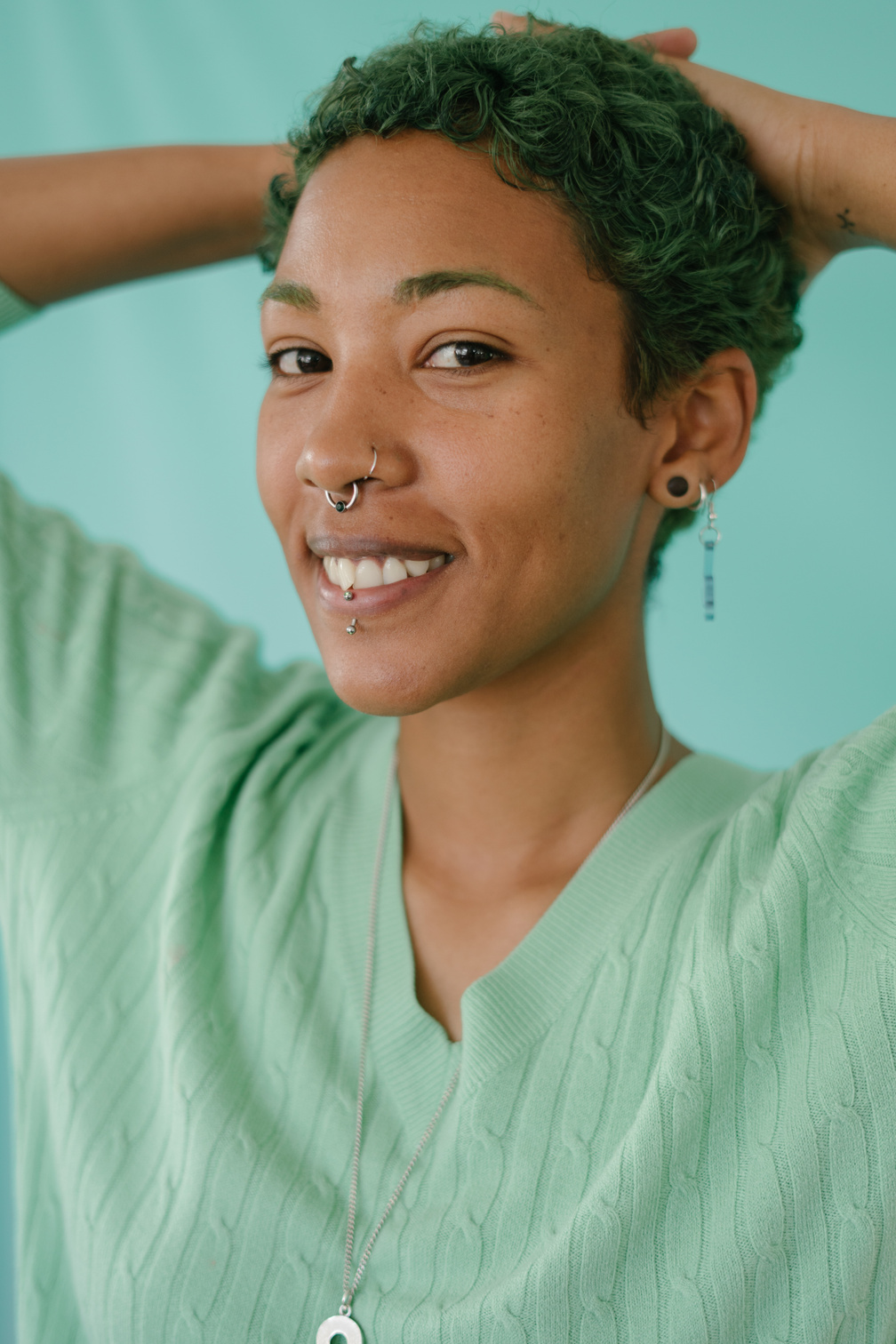 Smiling Woman in Shirt with Piercings on Nose, Lips, Ears